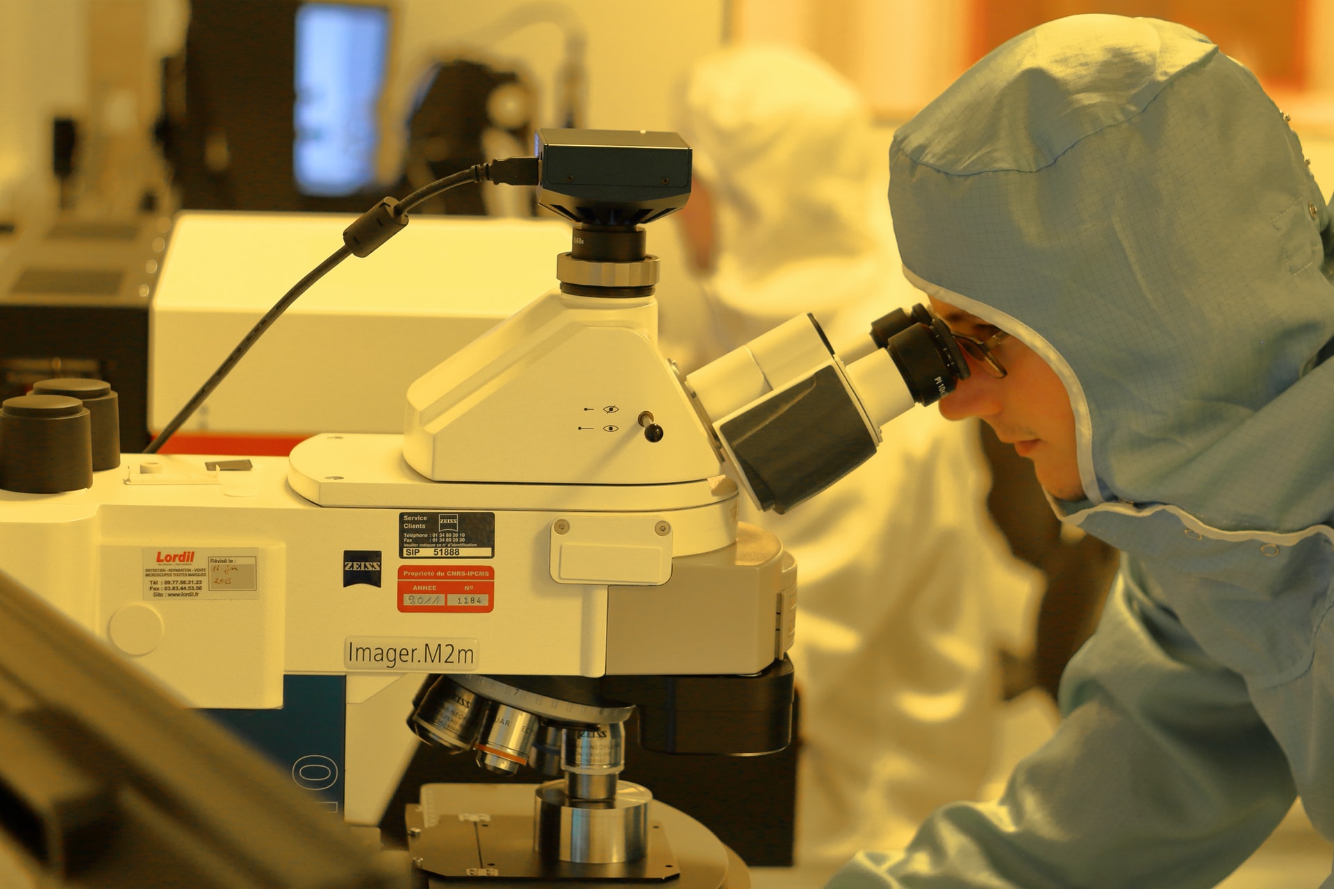 Scientist using a high powered microscope