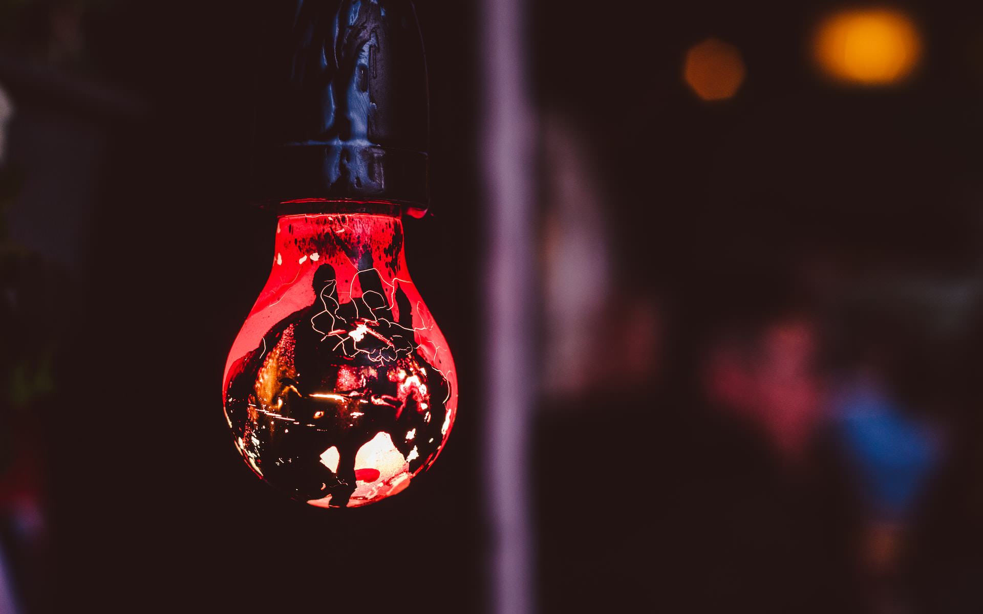 Red glass lightbulb glowing in a club